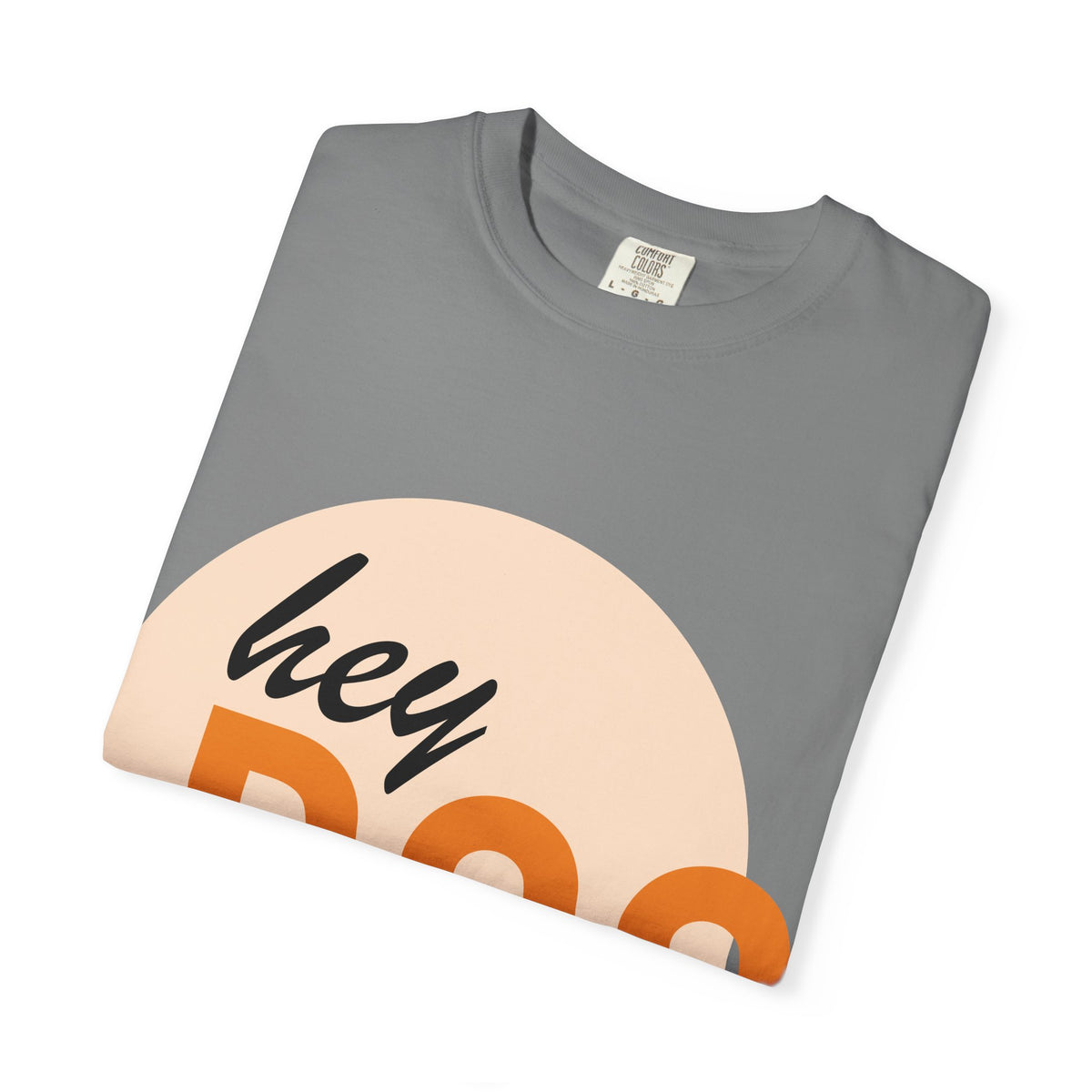 A folded gray crewneck t-shirt with a graphic print of a peach-colored sun, orange lettering, and the word 'hey' in black script, displayed on a clean white background.