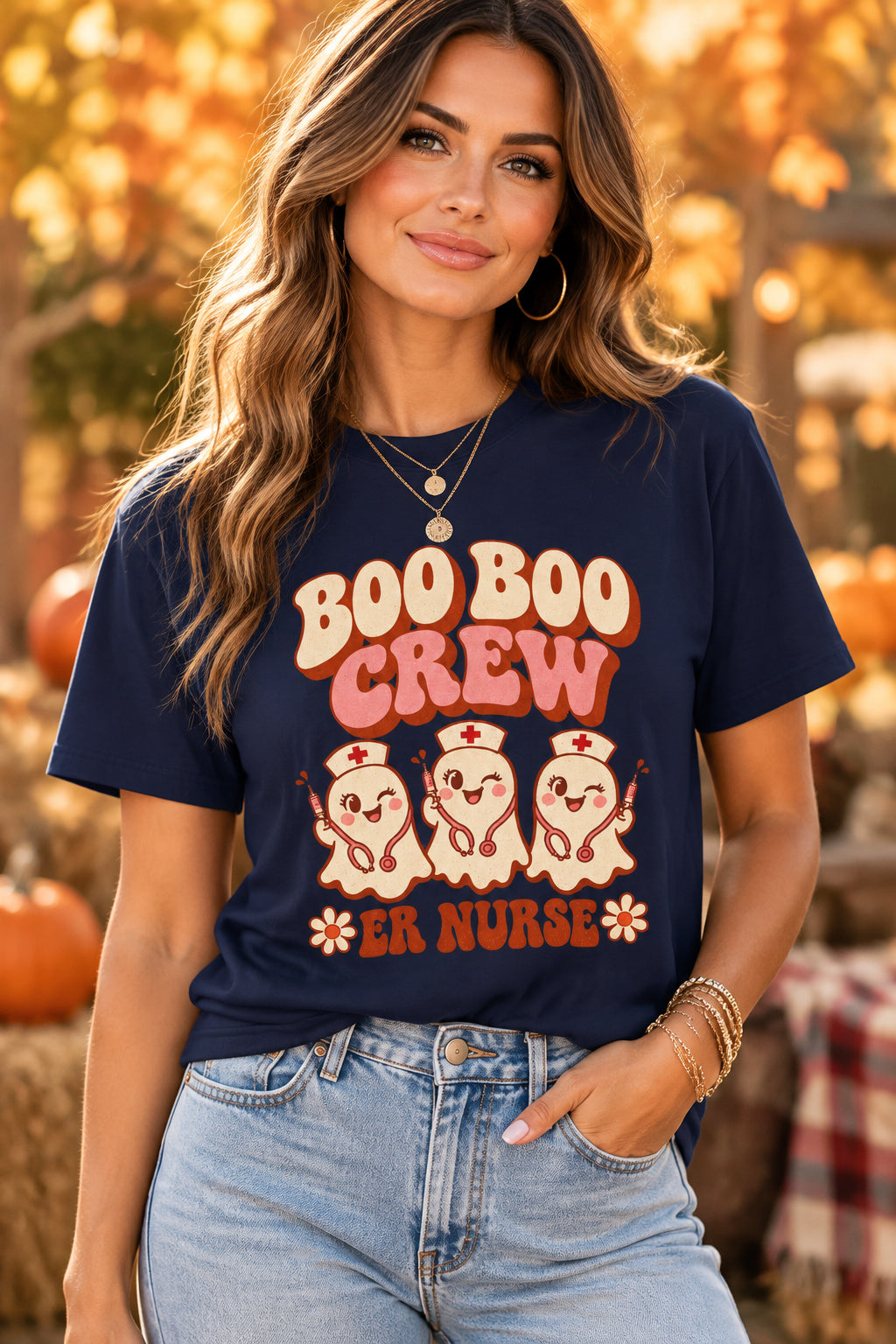 A navy blue short-sleeve t-shirt with a retro-style graphic on the chest that reads 'BOO BOO CREW ER NURSE' in orange and cream lettering, accompanied by three cartoon nurse ghosts.